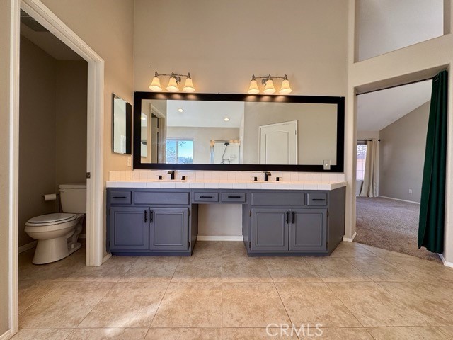40085 Temecky Way Murrieta, CA 92562 - Photo 33 of 55 a bathroom with a granite countertop sink and a toilet