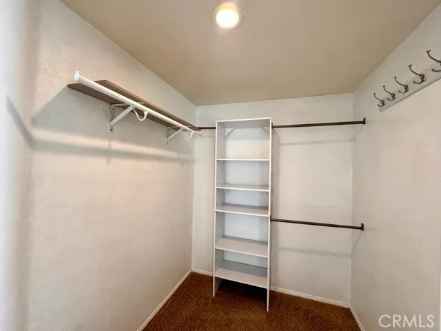 an empty room with closet and mirror