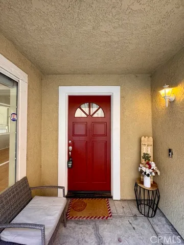 a view of an entryway with wooden floor and windows