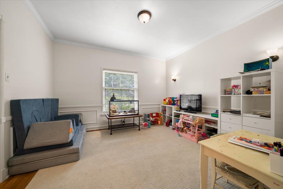 1273 Brookfield Road Memphis, TN 38119 - Photo 9 of 40 Bright interior space featuring a window with blinds, crown molding, and wainscoting details; currently being used as playroom