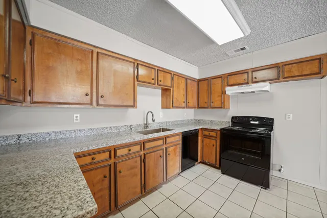 a kitchen with stainless steel appliances granite countertop a sink and cabinets