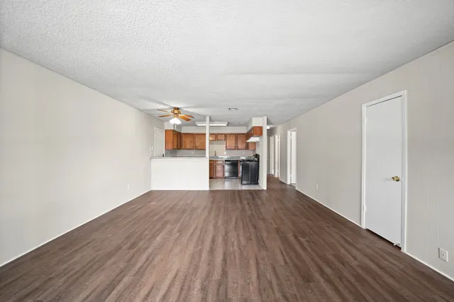 a view of wooden floor and windows in a room