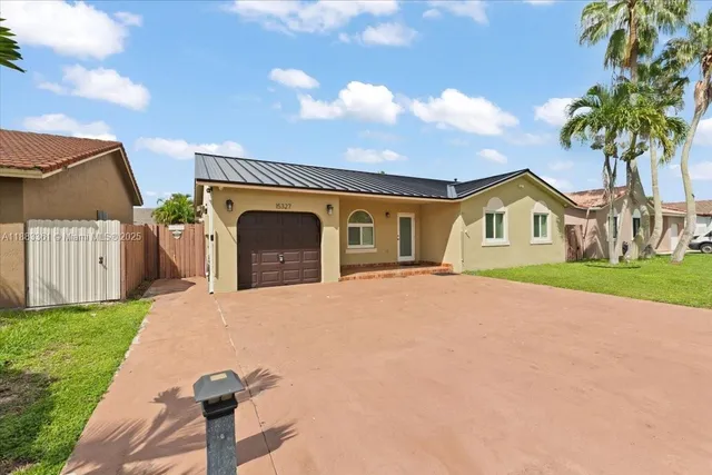 a front view of a house with a garden and yard
