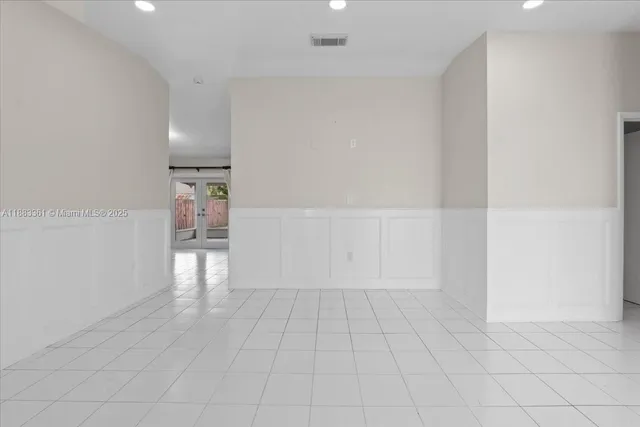 a view of an empty room and closet area