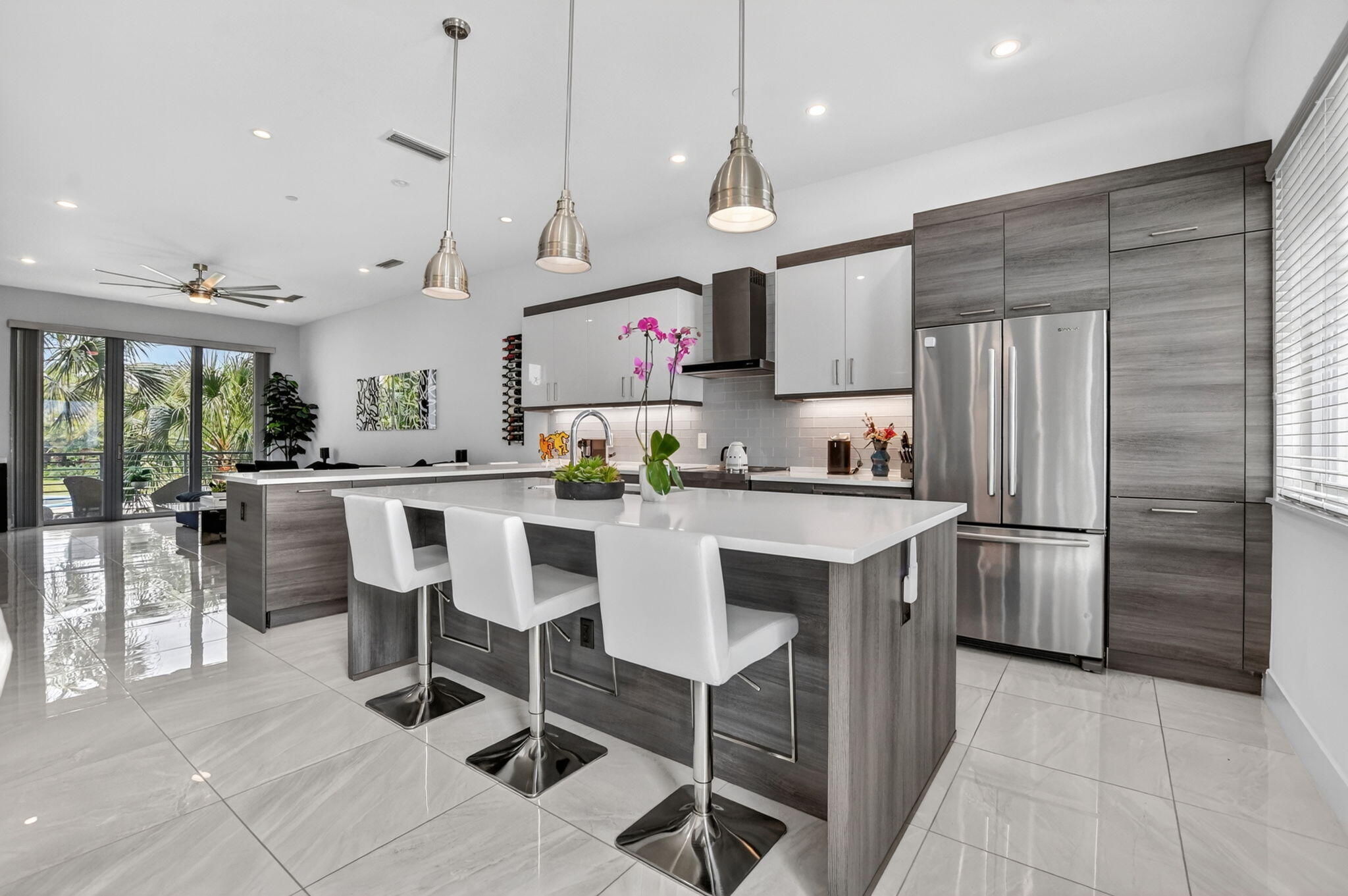 4021 Northwest 18th Way Boca Raton, FL 33431 - Photo 16 of 37 a kitchen with a refrigerator a sink and chairs