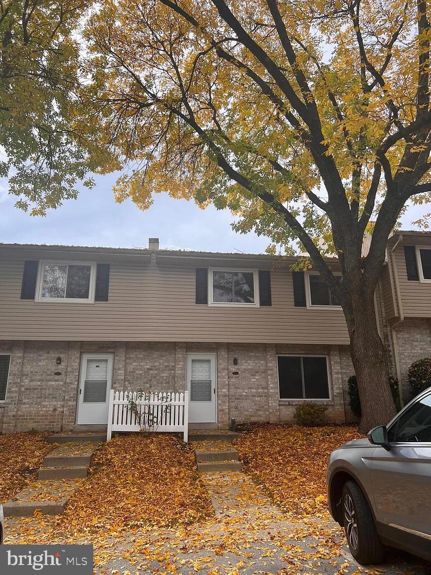 Charming townhouse amid autumn leaves.