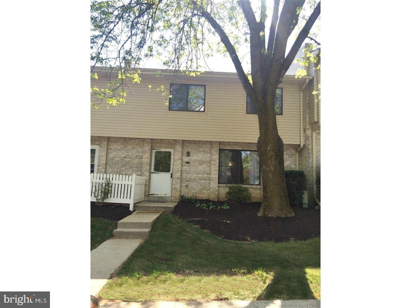 207 Village Walk, Unit 207 Exton, PA 19341 - Photo 15 of 17 Charming townhouse with lush greenery.