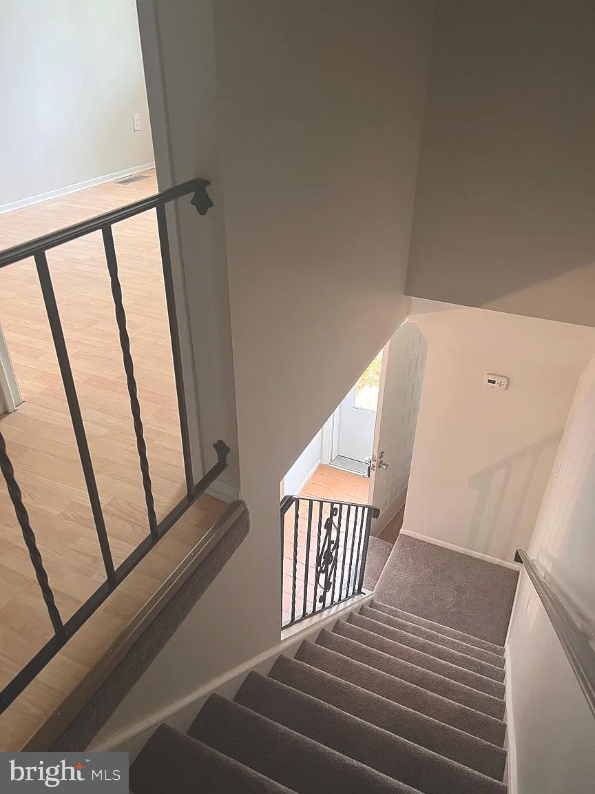 207 Village Walk, Unit 207 Exton, PA 19341 - Photo 10 of 17 Inviting staircase leading to bright entryway.
