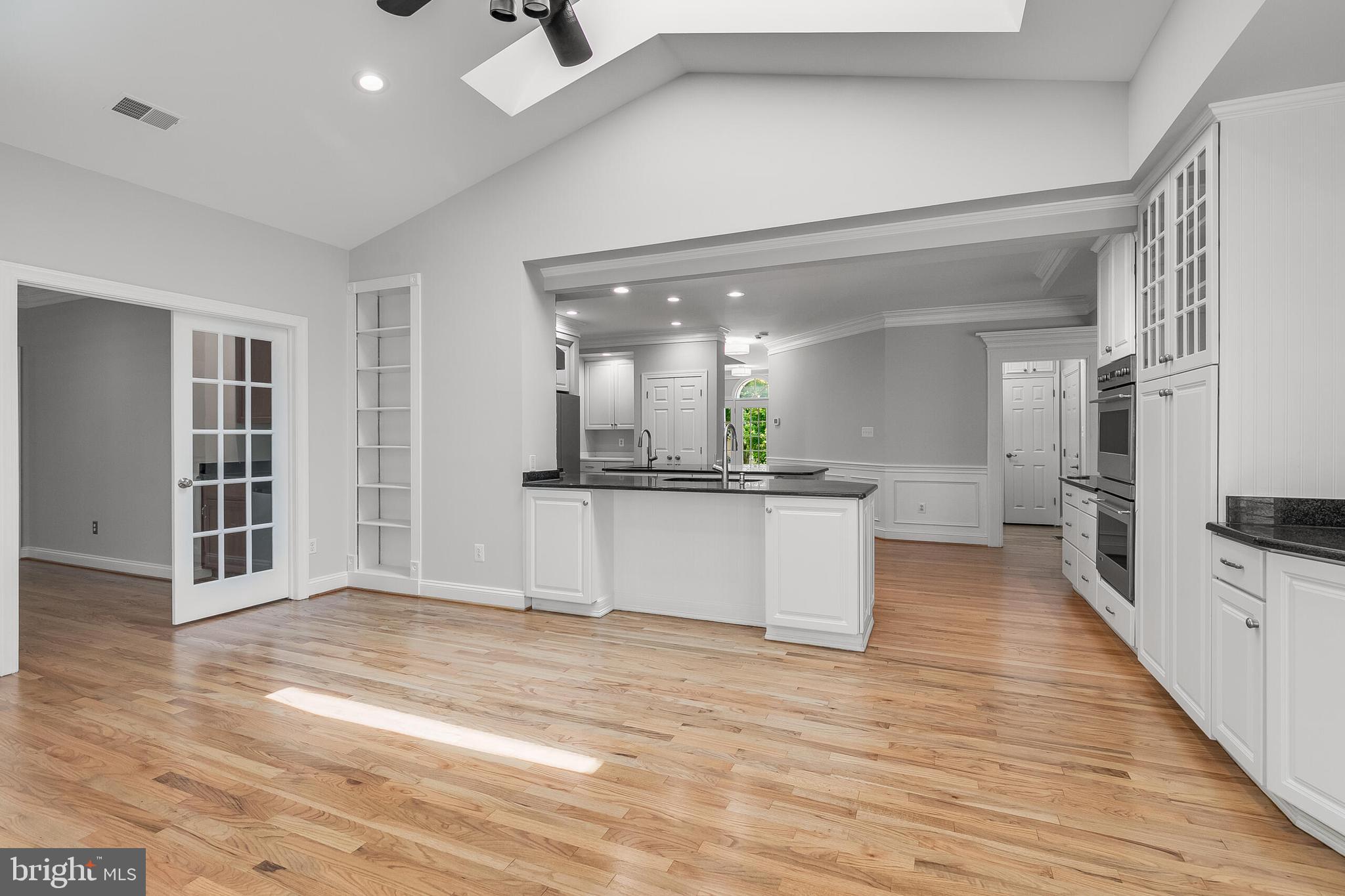 611 Catesby Court Southwest Leesburg, VA 20175 - Photo 33 of 96 a large kitchen with kitchen island a counter top space a sink stainless steel appliances and cabinets