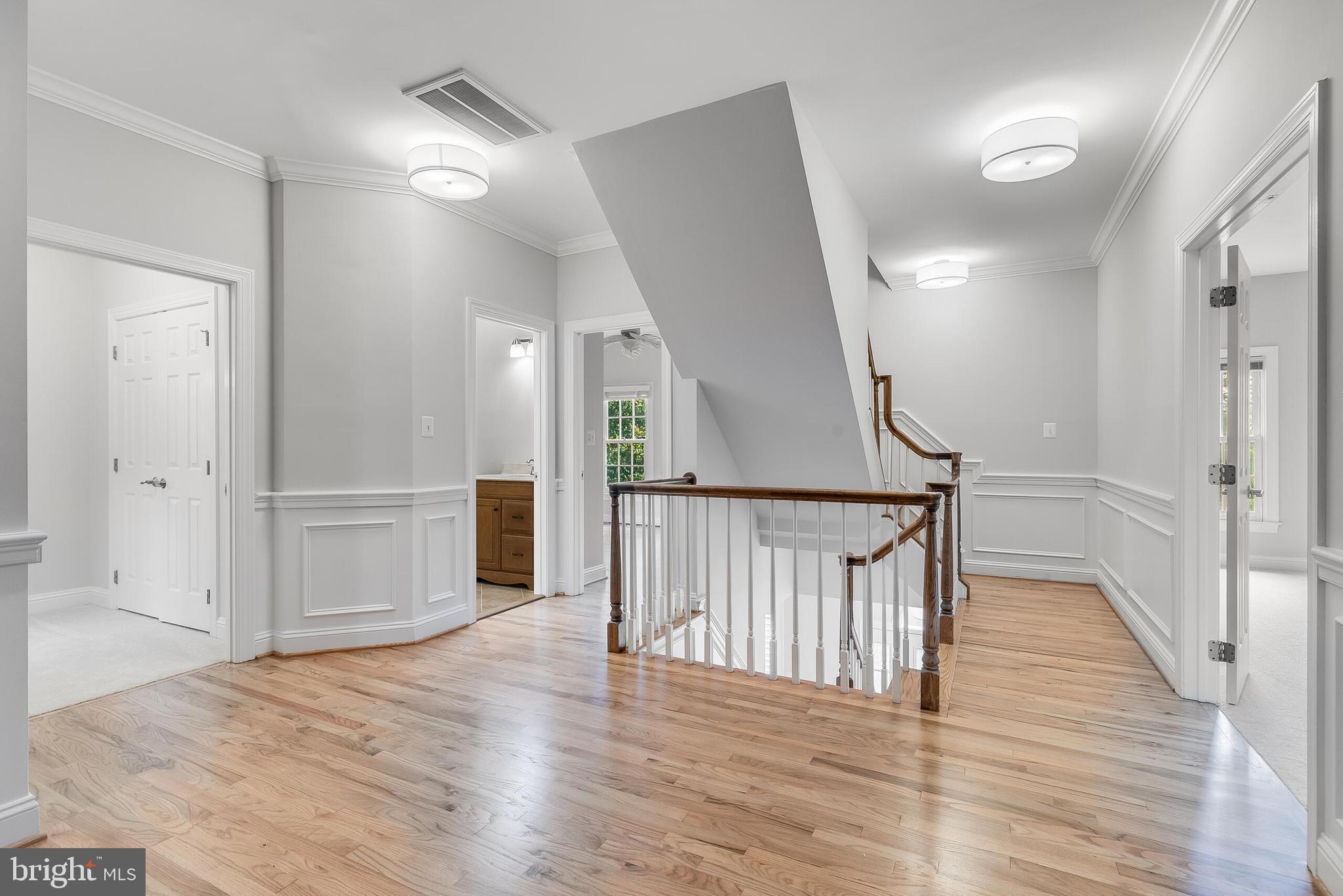 611 Catesby Court Southwest Leesburg, VA 20175 - Photo 46 of 96 a view of a hallway with wooden floor and stairs