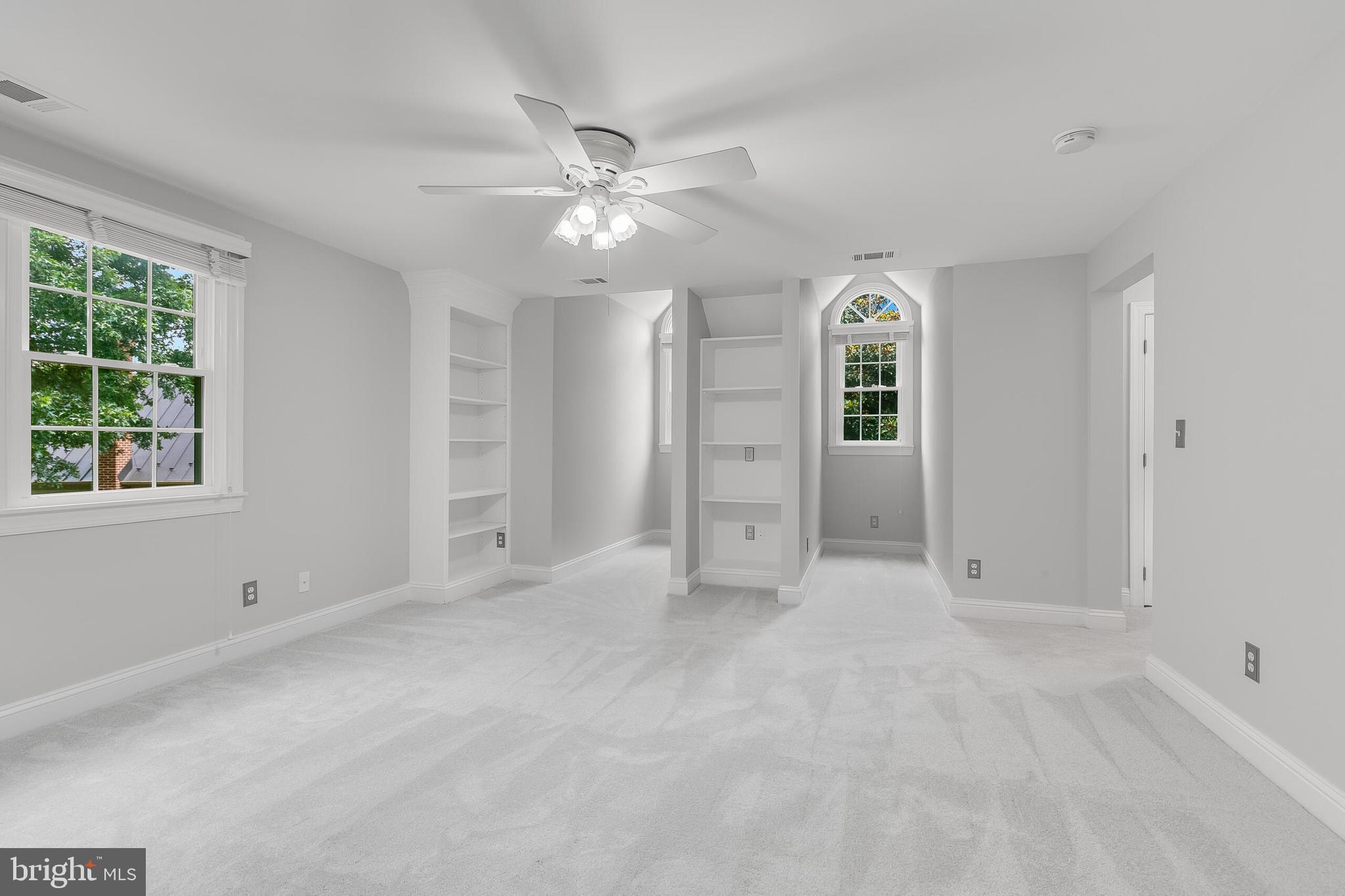 611 Catesby Court Southwest Leesburg, VA 20175 - Photo 54 of 96 an empty room with windows and fan chandelier