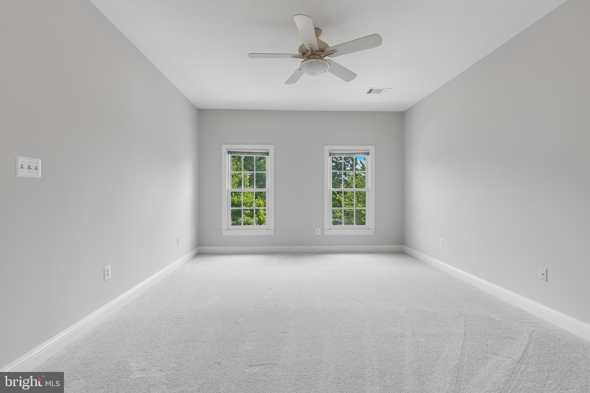 611 Catesby Court Southwest Leesburg, VA 20175 - Photo 57 of 96 an empty room with windows and ceiling fan