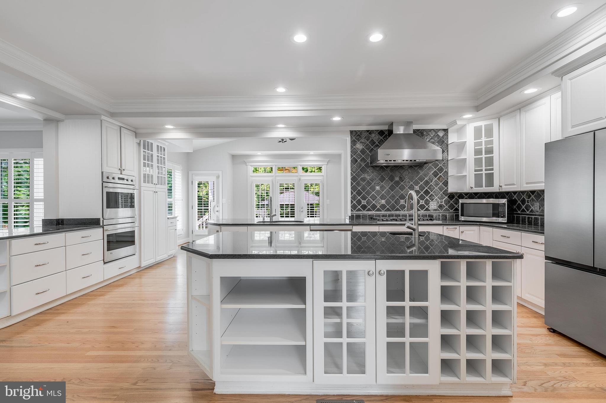 611 Catesby Court Southwest Leesburg, VA 20175 - Photo 6 of 96 a large white kitchen with a center island and stainless steel appliances