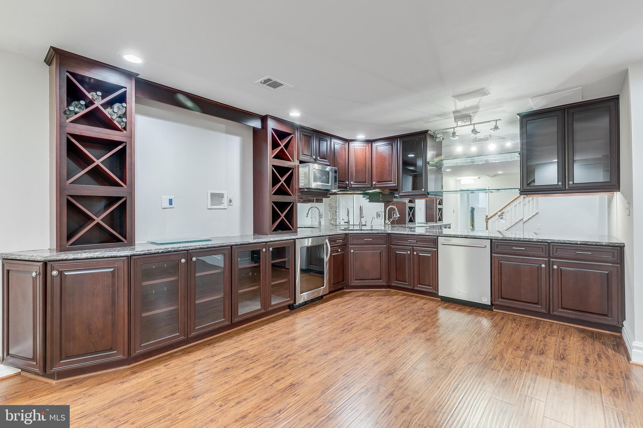 611 Catesby Court Southwest Leesburg, VA 20175 - Photo 74 of 96 a kitchen with stainless steel appliances kitchen island granite countertop a sink counter space and cabinets