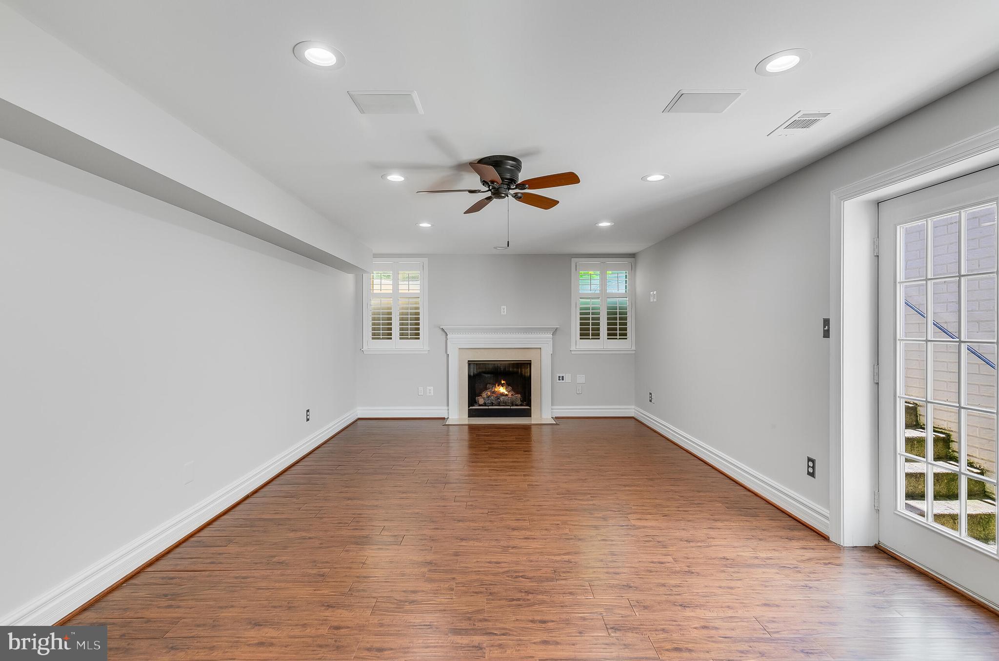 611 Catesby Court Southwest Leesburg, VA 20175 - Photo 77 of 96 an empty room with fireplace and windows