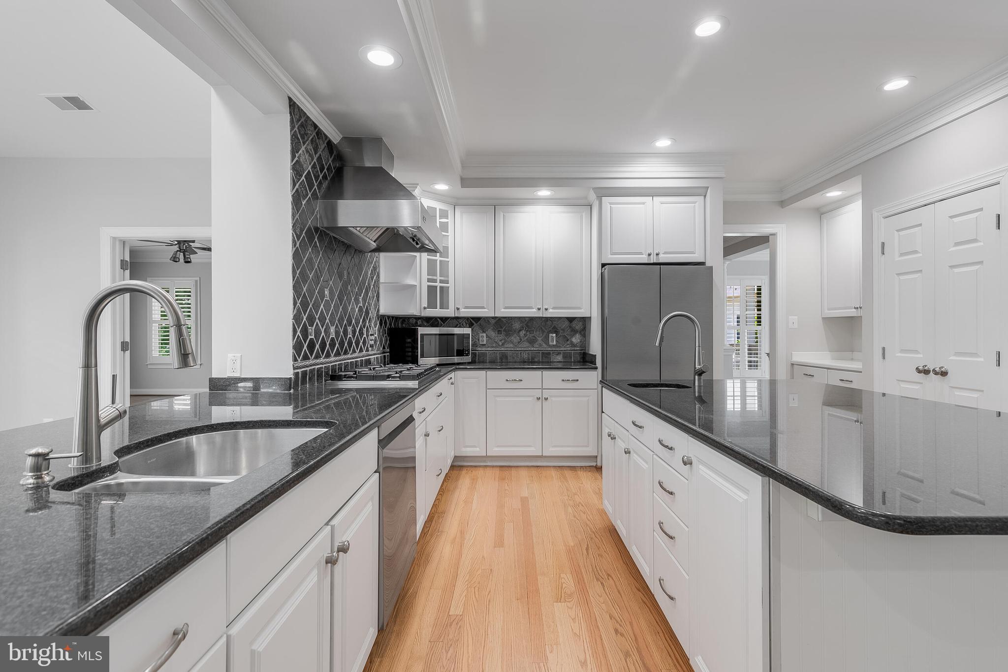 611 Catesby Court Southwest Leesburg, VA 20175 - Photo 8 of 96 a large kitchen with stainless steel appliances granite countertop a sink stove and refrigerator