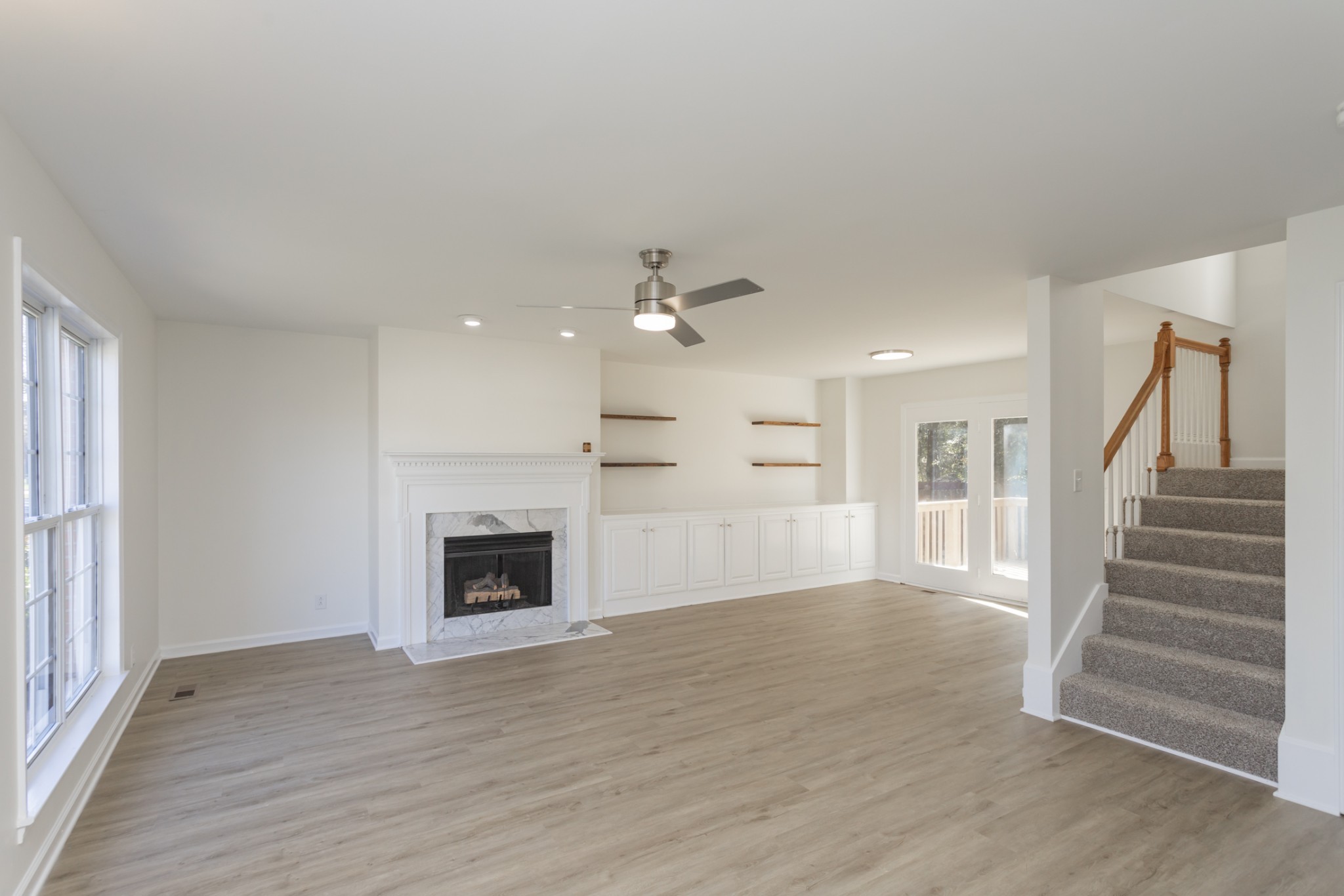 156 Foxrun Springfield, TN 37172 - Photo 8 of 33 an empty room with wooden floor fireplace and window