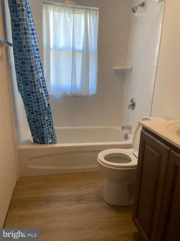 a bathroom with a toilet a sink and bathtub