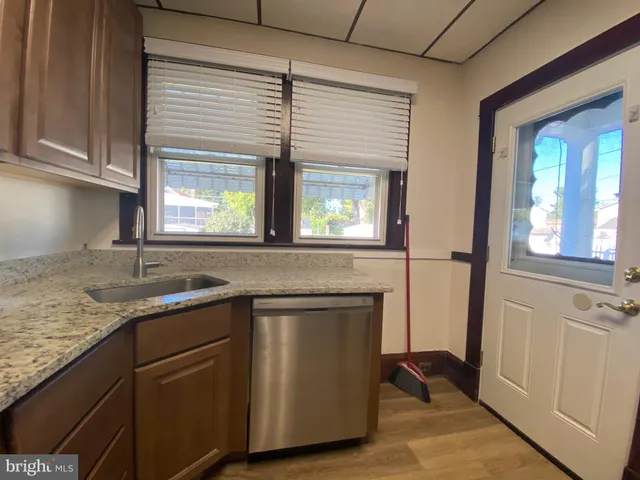 a kitchen with granite countertop a sink and a window