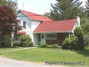 8725 Neville Road Moscow, PA 18444 - Photo 1 of 8 a view of a house with garden and yard