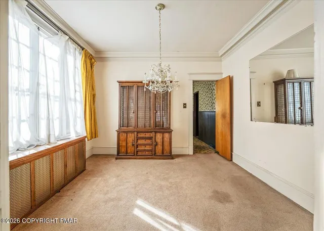 a view of a bedroom with window and furniture