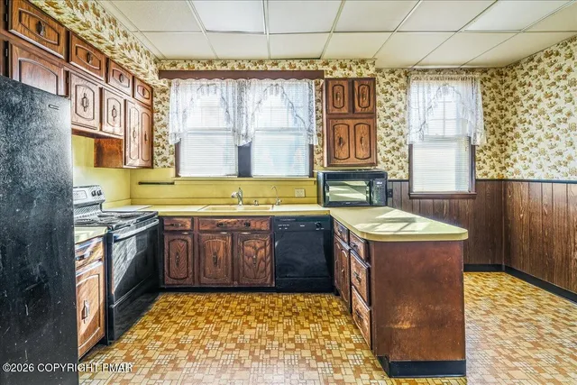 a kitchen with a stove a sink and a refrigerator