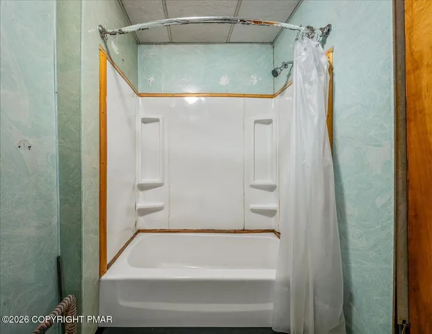 a bathroom with a shower and a tub