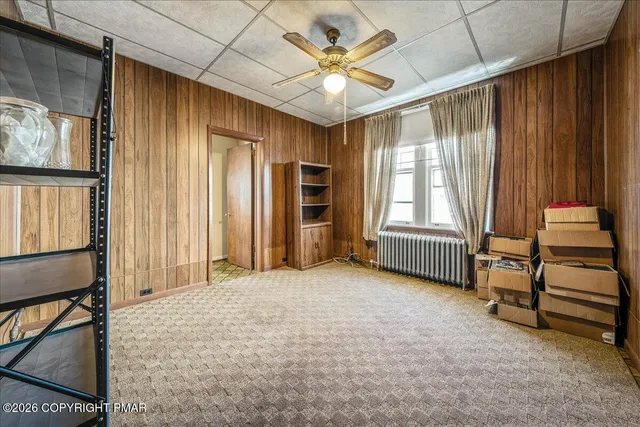 a view of a livingroom with furniture and staircase