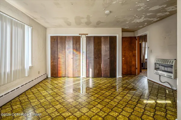 a view of a hallway with a dining area