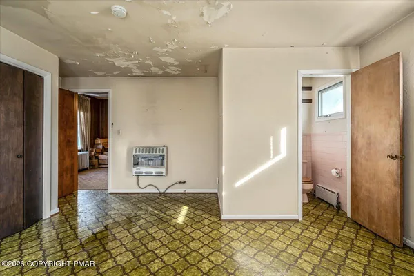 a bathroom with a granite countertop toilet sink and mirror