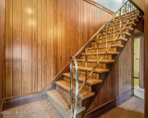 a view of entryway with wooden floor and stairs