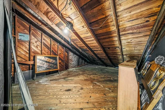 a view of a room with wooden table and chairs