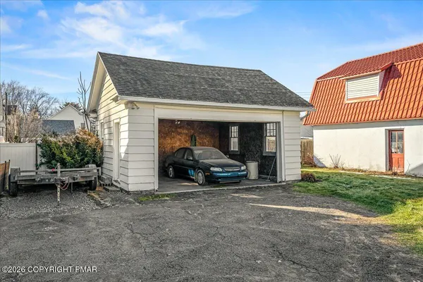 a view of a car parked in front of a house