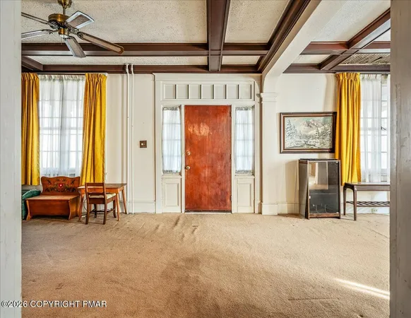 a view of an front door with furniture and a window