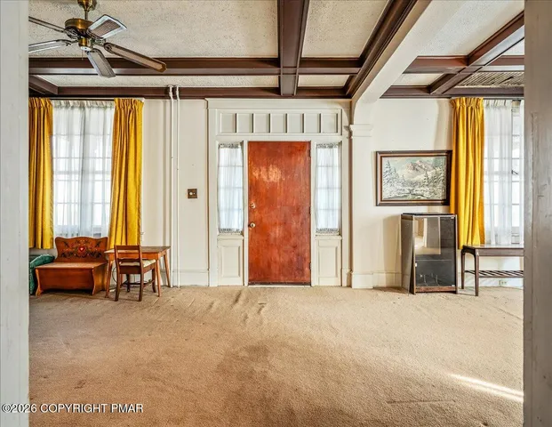 a view of an front door with furniture and a window