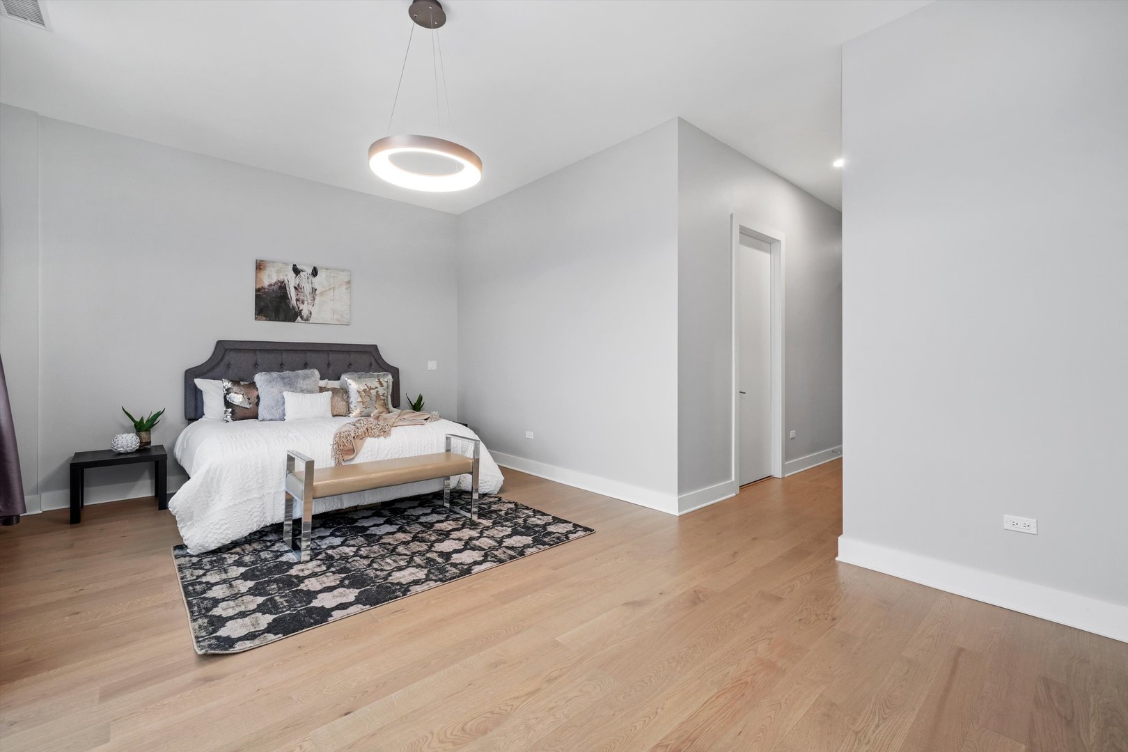 1128 West Adams Street, Unit 4E Chicago, IL 60607 - Photo 19 of 31 a bedroom with a bed and wooden floor