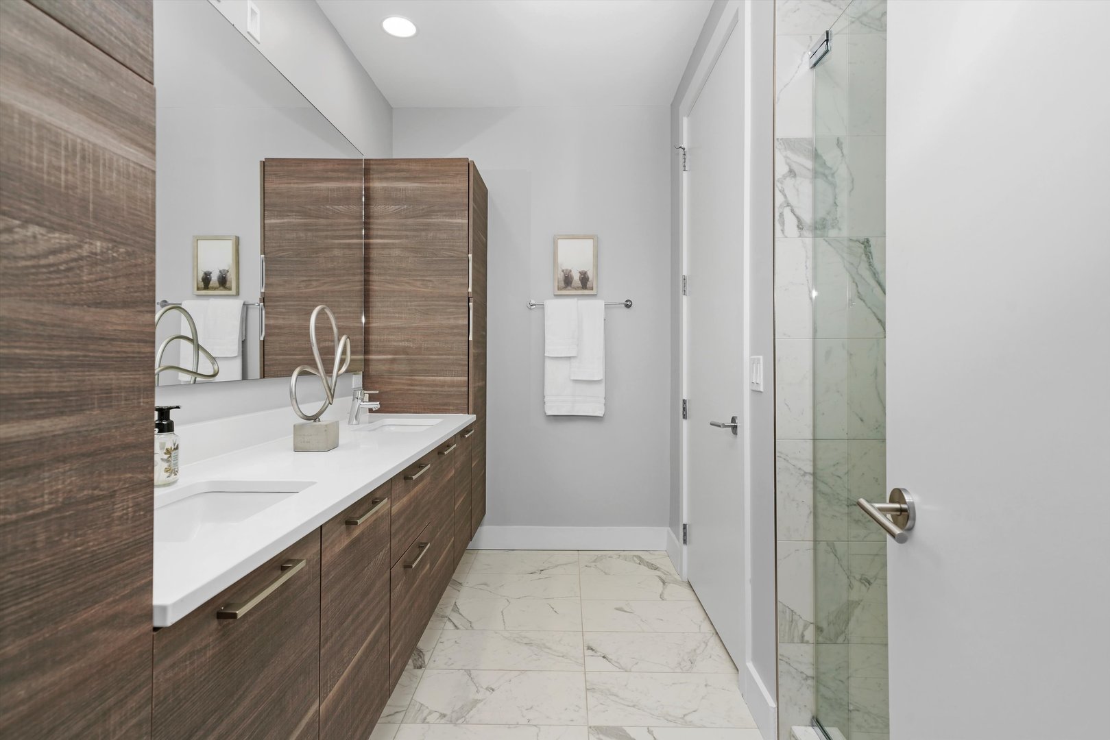 1128 West Adams Street, Unit 4E Chicago, IL 60607 - Photo 24 of 31 a bathroom with a double vanity sink and mirror
