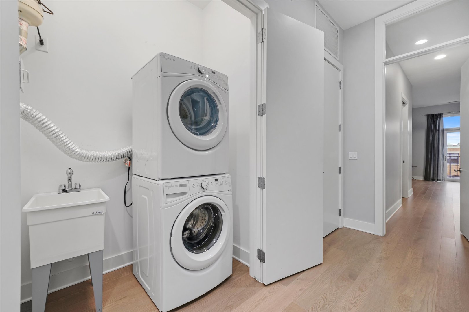 1128 West Adams Street, Unit 4E Chicago, IL 60607 - Photo 26 of 31 a view of a hallway with washer and dryer