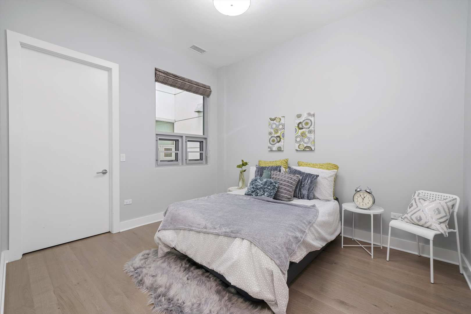 1128 West Adams Street, Unit 4E Chicago, IL 60607 - Photo 10 of 31 a bedroom with a bed and a chair