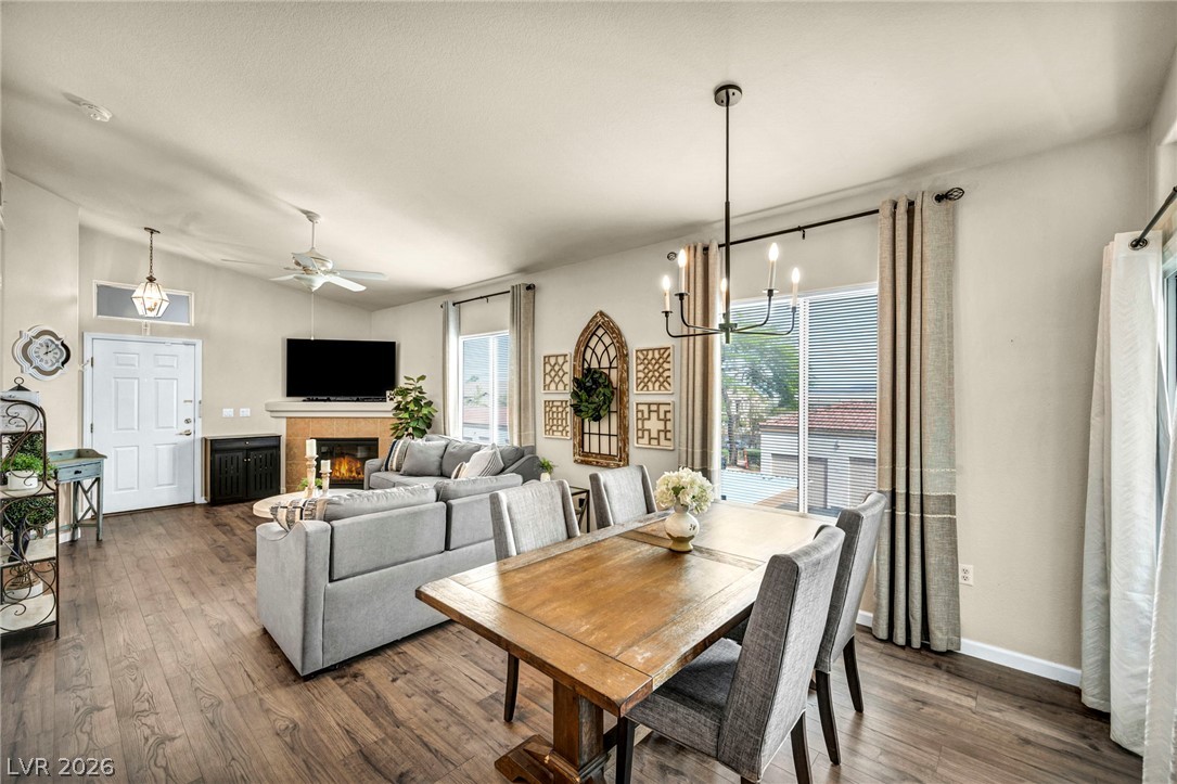 2305 West Horizon Ridge Parkway, Unit 3621 Henderson, NV 89052 - Photo 18 of 23 An inviting open-concept living space features warm wood flooring and a dining area illuminated by a chic chandelier.