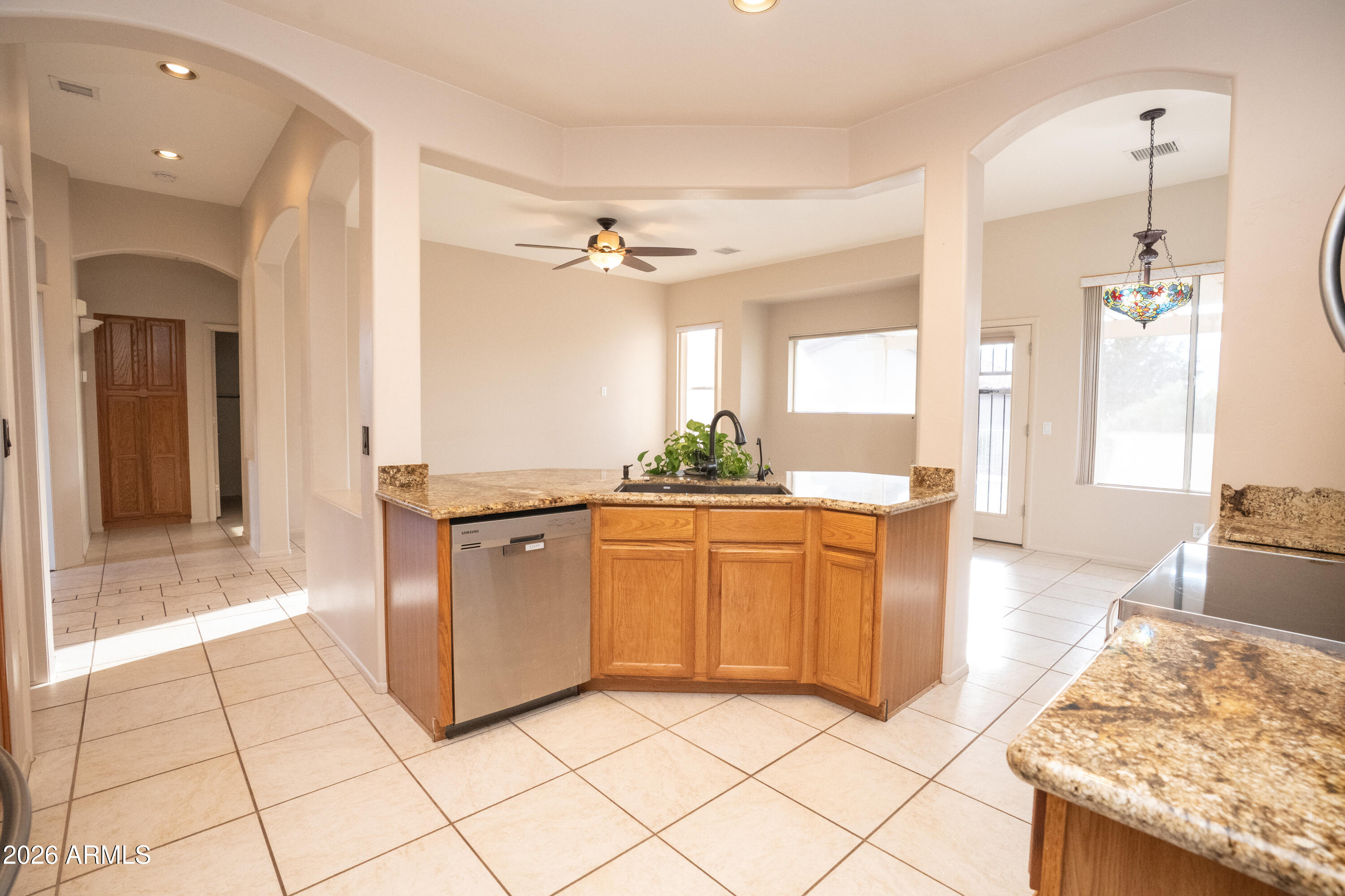 5320 Painted Desert Road Cornville, AZ 86325 - Photo 14 of 58 a large kitchen with kitchen island granite countertop a sink and a stove top oven