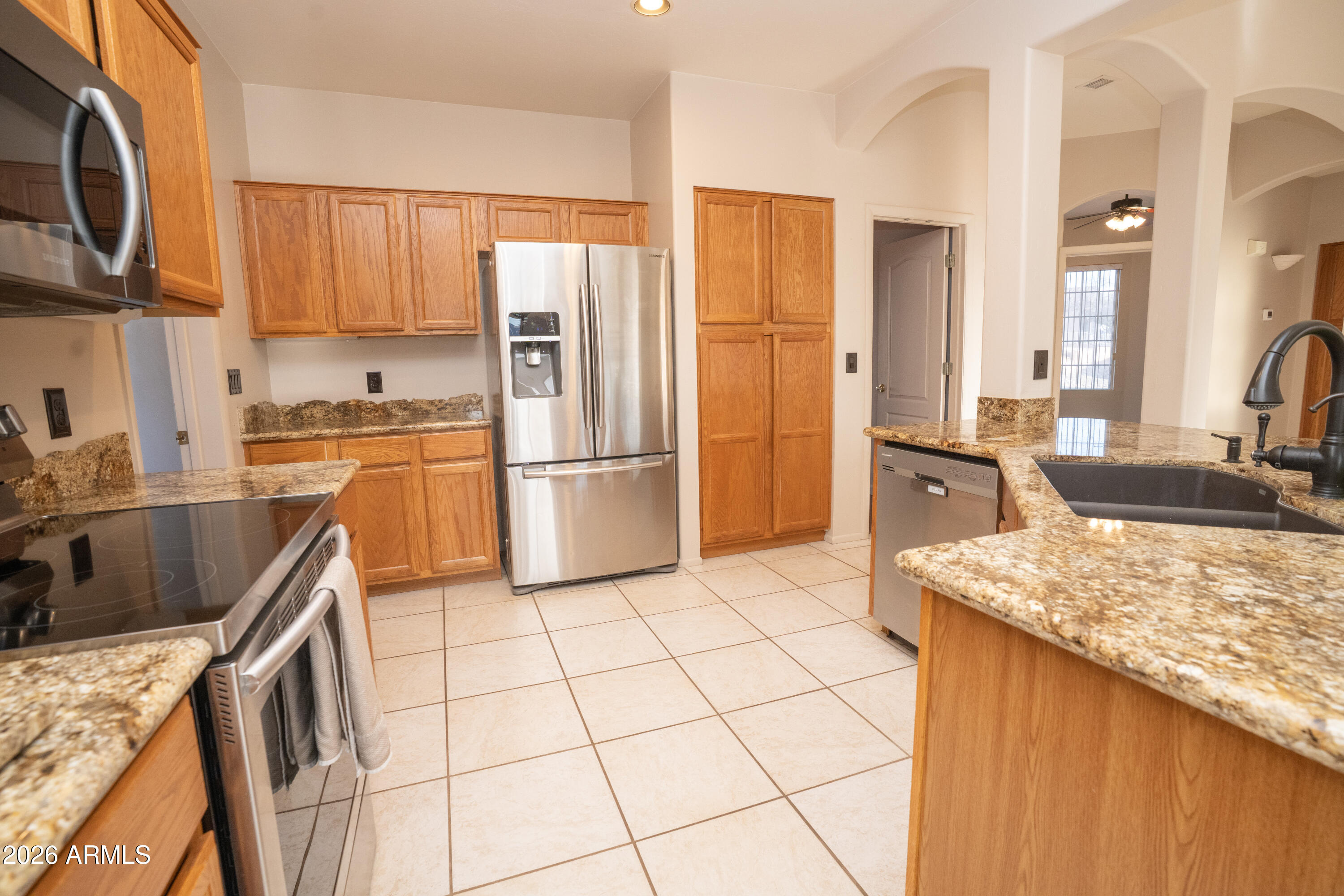 5320 Painted Desert Road Cornville, AZ 86325 - Photo 15 of 58 a kitchen with stainless steel appliances granite countertop a refrigerator stove top oven a sink and dishwasher