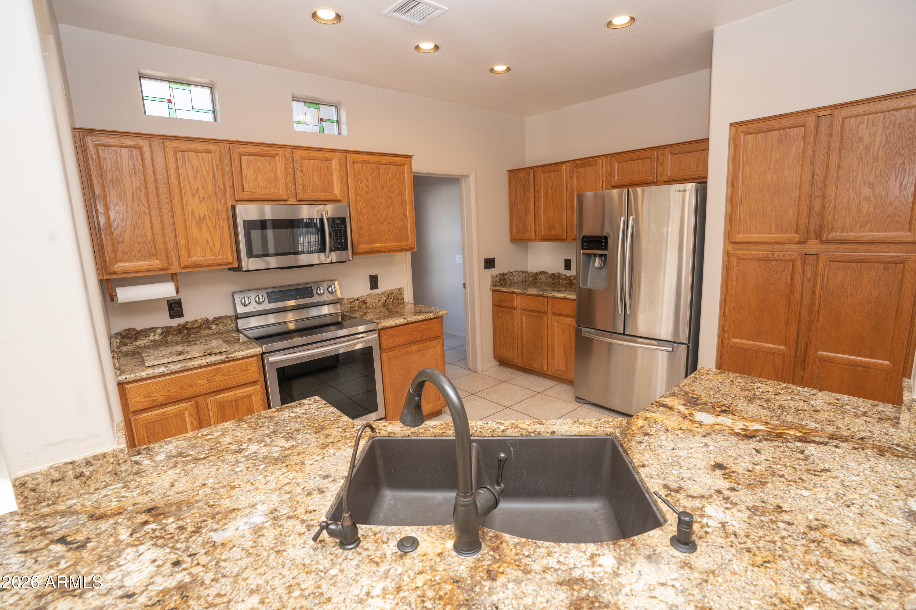 5320 Painted Desert Road Cornville, AZ 86325 - Photo 17 of 58 a kitchen with stainless steel appliances kitchen island granite countertop a refrigerator and a stove top oven