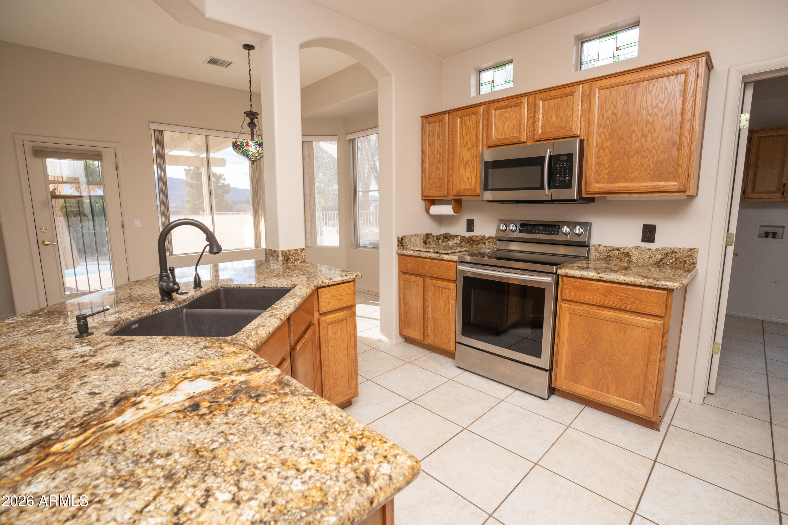 5320 Painted Desert Road Cornville, AZ 86325 - Photo 19 of 58 a kitchen with stainless steel appliances granite countertop a stove a sink and a microwave