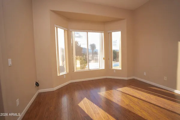 a room with a sink and a stove with wooden floor