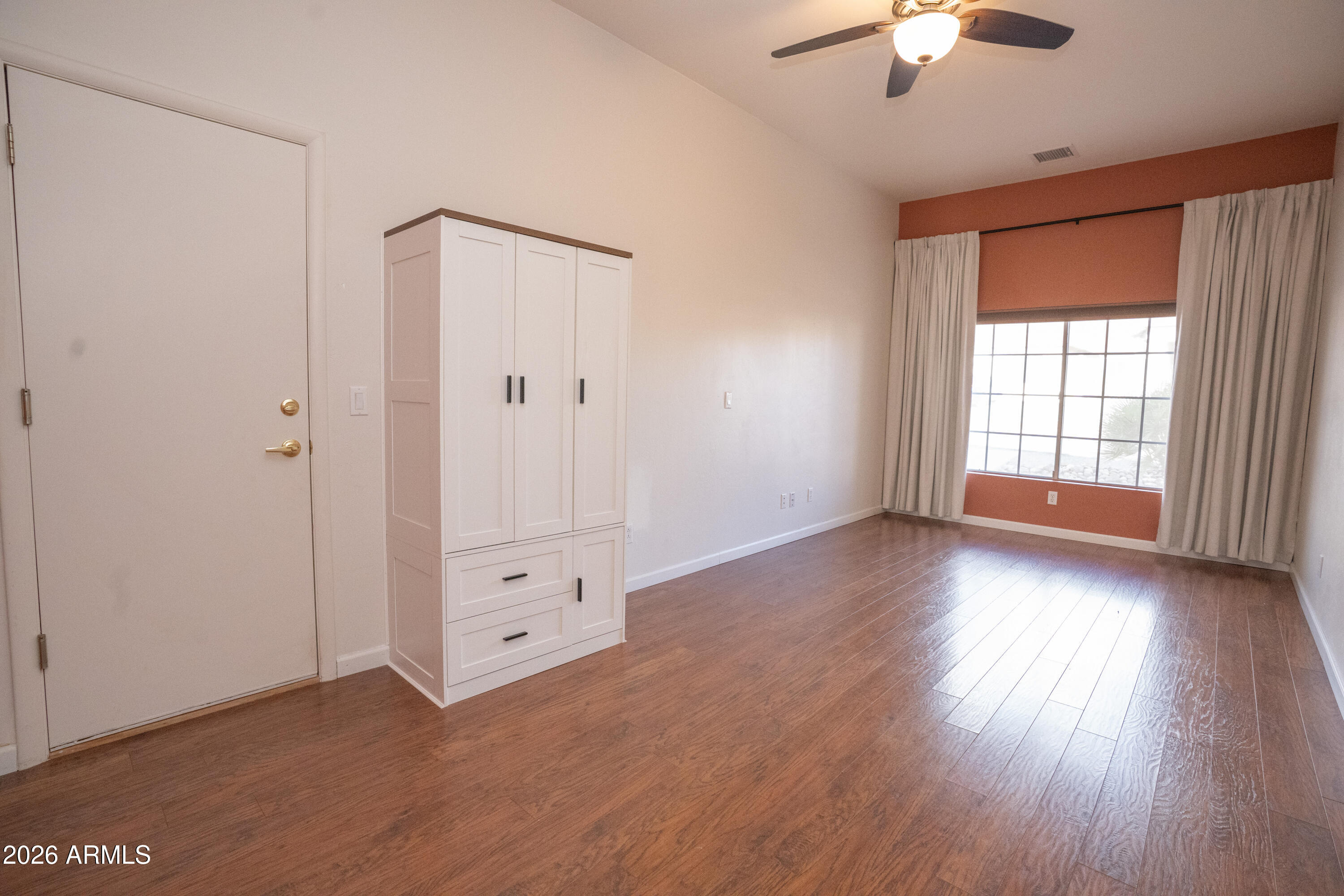 5320 Painted Desert Road Cornville, AZ 86325 - Photo 34 of 58 an empty room with wooden floor chandelier fan and windows