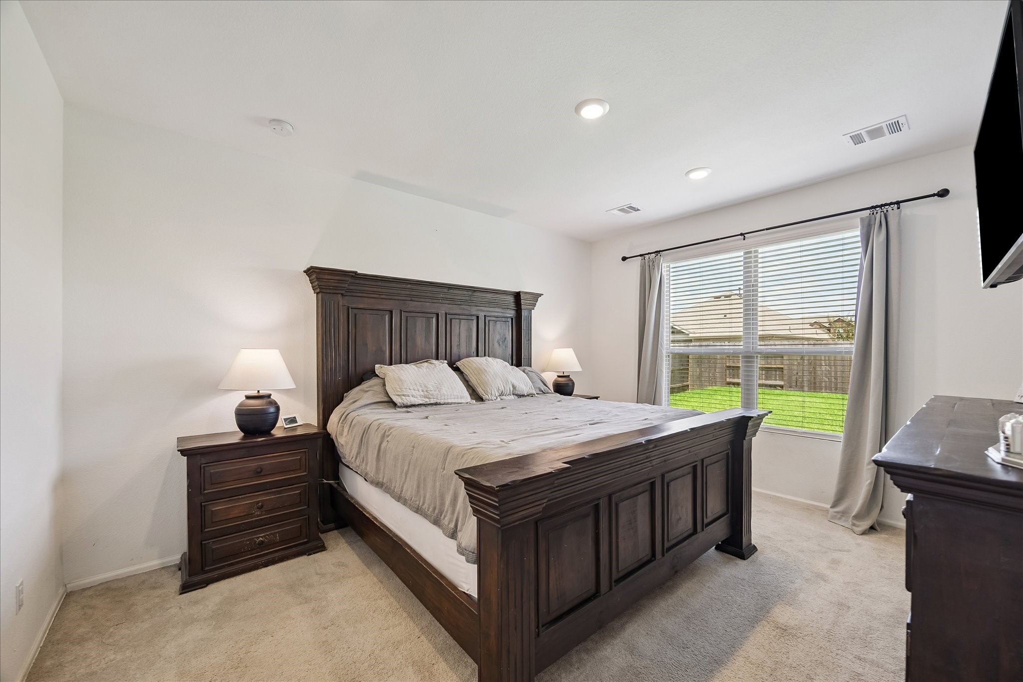 3812 Moss Hl Road Rosenberg, TX 77469 - Photo 4 of 20 This bedroom features soft carpeting, and ample natural light from a generous window overlooking the backyard.