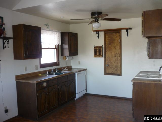 21980 Panhandle Road Reno, NV 89521 - Photo 3 of 9 a kitchen with a sink stove and refrigerator