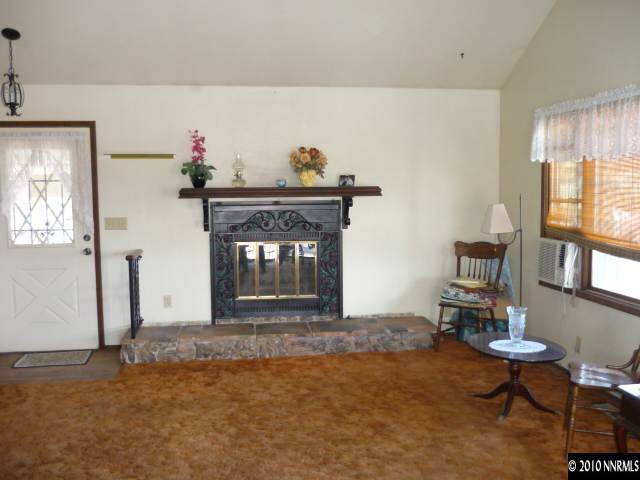 21980 Panhandle Road Reno, NV 89521 - Photo 4 of 9 a living room with furniture and a fireplace