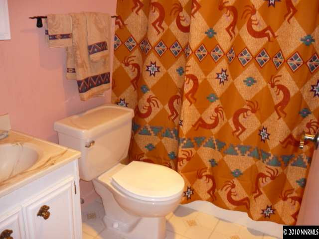 21980 Panhandle Road Reno, NV 89521 - Photo 9 of 9 a white toilet sitting next to a shower curtain